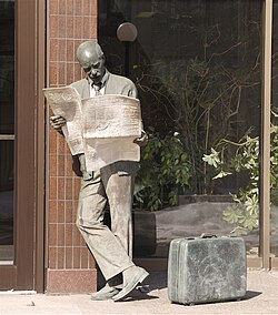 A statue in Westmount of man reading The Gazette