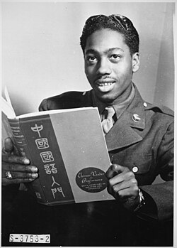 "Pvt. Lloyd A. Taylor, 21-year-old transportation dispatcher at Mitchel Field, New York City, who knows Latin, Greek, Spanish, French, German, and Japanese, studies a book on Chinese. A former medical student at Temple University, he passes two hours a day studying languages as a hobby."This picture was taken during World War II.