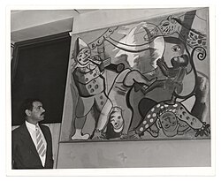 Artist Louis Schanker with one of his murals within Neponsit Hospital in 1939