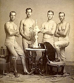 Yale University's four-oared crew team, posing with the 1876 Centennial Regatta trophy