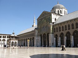 The Umayyad Mosque in Damascus built by Caliph Al-Walid I followed the plan of the Prophet's Mosque in Medina, and became the earliest example of a congregational mosque that served as standard for future mosques[65]