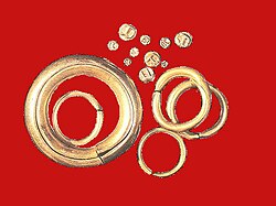 The Piloncitos are tiny engraved gold coins found in the Philippines, along with barter rings, which are gold ring-like ingots. These barter rings are bigger than softballs in size and are made of pure gold from the Archaic period (c. 10th to 16th century).[86]