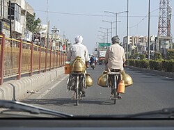 Vendors in Amritsar, India transporting milk in gagar, 2019