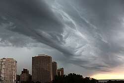 A shelf cloud at the leading edge of a thunderstorm complex on the South Side of Chicago that extends from the Hyde Park community area to over the Regents Park twin towers and out over Lake Michigan