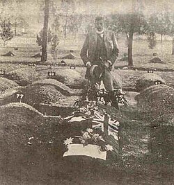 Major James Francis Thomas standing over the joint grave of Breaker Morant and Peter Handcock, officers executed after a 1902 court-martial.