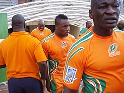 A close-up shot of the Ivory Coast players, in their country's orange jerseys, entering the field from the dressing room tunnel