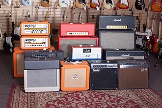 A collection of guitar amplifier heads, cabinets, and combos.