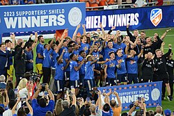 Captain Luciano Acosta holds up the Supporters' Shield after Cincinnati clinched it in 2023.