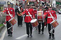 Line infantry full dress (Duke of Wellington's Regiment): Regimental Drummers scarlet full dress tunic of pre–World War I pattern, Home Service helmet of 1878.
