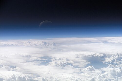 A view of the Earth's atmosphere with the Moon beyond