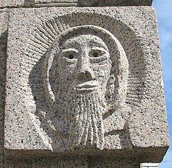The face of St Helier as sculpted on the 1978 monument La Croix de la Reine in St Helier.