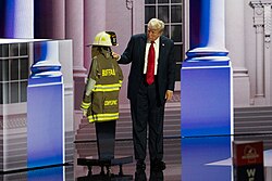 Trump at the RNC standing alongside the fire department uniform of Corey Comperatore, who was killed during the attempted assassination of Trump