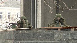 Unmarked Russian soldiers ("Little Green Men") outside the occupied parliament of Crimea