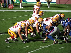 The Redskins gather at the line of scrimmage against the Giants.