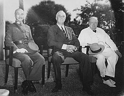 Three men, Chiang Kai-shek, Franklin D. Roosevelt, and Winston Churchill, sitting together elbow to elbow
