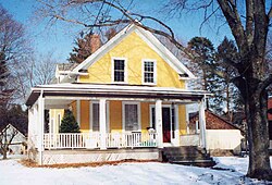 A gablefront house with a veranda porch