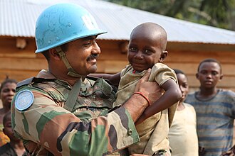 Indian Peacekeeper with a child in Congo (for MONUSCO mission), 2000