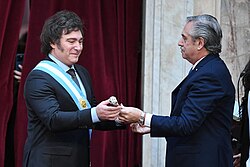 Alberto Fernández awarding Milei the presidential scepter during the inauguration on 10 December 2023