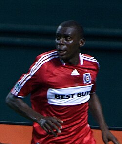 Bakary Soumaré wearing the all-red shirt with a white horizontal chest stripe. This was the club's primary kit until 2012.