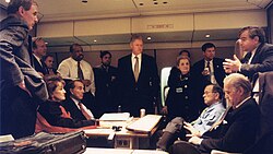 Photo of Clinton, his senior officials, and Biden on Air Force One
