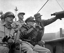 General Douglas MacArthur, UN Command CiC (seated), observes the naval shelling of Incheon, Korea from USS Mt. McKinley, 15 September 1950