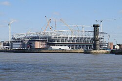 Bramley-Moore Dock Stadium, one of the projects that resulted in Liverpool Maritime Mercantile City being delisted, under construction in April 2023 with the Victoria Tower to the right