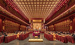 Buddhist monks and nuns praying in the Buddha Tooth Relic Temple of Singapore