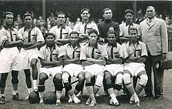 The Indian team at 1948 Olympics, captain Talimeren Ao at the centre of first row, goal scorer Sarangapani Raman next to Ao and coach Balaidas Chatterjee to the furthest right.
