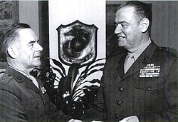 Commandant Wallace M. Greene congratulates Deputy Chief of Staff for Plans and Programs, Henry W. Buse Jr. on his promotion to lieutenant general on December 30, 1964.