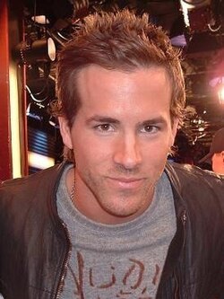 Reynolds staring towards the camera with a slight smirk on his face