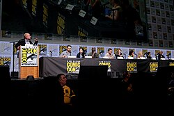 Cast and crew of The Defenders at the 2017 San Diego Comic-Con. From left to right: executive producer Jeph Loeb, stars Charlie Cox, Krysten Ritter, Mike Colter, Finn Jones, Sigourney Weaver, Elodie Yung, Deborah Ann Woll, and Jessica Henwick, and showrunner Marco Ramirez.