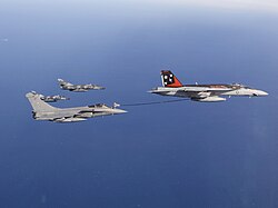An F/A-18E Super Hornet of the US Navy acts as a buddy tanker for a Rafale of the French Navy over the Arabian Sea, 2015