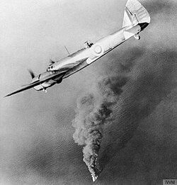 Embry, at the controls of a Bristol Blenheim, circles over a British tanker on fire and sinking in the English Channel, February 1940