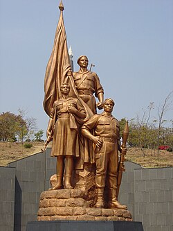 Statues atop the tomb of the Unknown Soldier at Heroes' Acre; the monument was designed by North Korean architects who reported directly to Mugabe.[166]