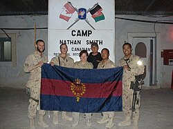 Canadian Grenadier Guards carry their regimental flag at Camp Nathan Smith in Afghanistan, 2008