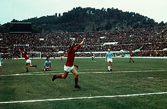 Giancarlo De Sisti and teammates, arms upraised. An opponent had fallen to his knees.