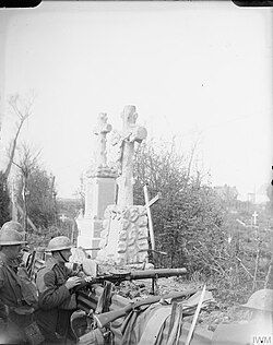 Troops of the 10th (Service) Battalion, Queen's Own (Royal West Kent) Regiment manning a Lewis machine gun in a front line trench running through a cemetery in the Ypres Salient, Belgium, 29 April 1918.