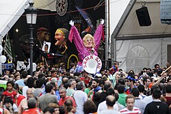 Marijaia and the konpartsak during the Aste Nagusia, with Gigantes y cabezudos in the background