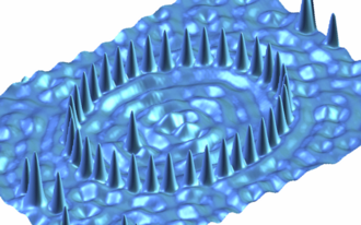 Scanning tunneling microscopy image of an elliptical quantum corral built by Co atoms on a Cu surface.