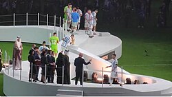 Angel Di María (11) kissing the trophy; besides him, goalkeeper Gerónimo Rulli (12)