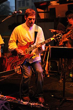 Altman, playing guitar at a fundraiser in San Francisco, is a hobbyist musician.