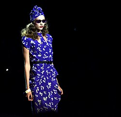 Karlie Kloss showcases an Anna Sui dress at New York Fashion Week, Sui's collections have been designed and manufactured in New York's Garment Center since 1981.