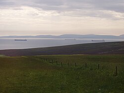 Petroleum tankers wait at anchor in Scapa Flow. The calm waters, relative to the North Sea, provide a safe harbour for the oil terminal at Flotta.