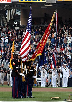 A Marine colour guard dips the Marine flag for "The Star-Spangled Banner".