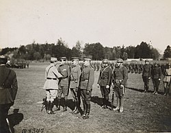 French General Georges de Bazelaire decorates MacArthur with the Croix de Guerre, 18 March 1918