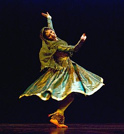 A dancer posing during a kathak dance sequence. The dance has its origins in Northern India and especially Lucknow.