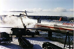 A de-icing vehicle treating an American Airlines McDonnell Douglas MD-80 at Syracuse Hancock International Airport, New York