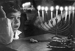 Boy in front of a menorah