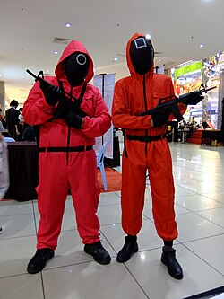 People cosplaying as guards from Squid Game