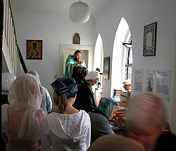 Russian Orthodox priest hearing confessions before Divine Liturgy, Church of the Protection of the Theotokos, Düsseldorf, Germany.